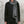Load image into Gallery viewer, Person wearing a black outfit with a gray linen scarf against a textured wall.
