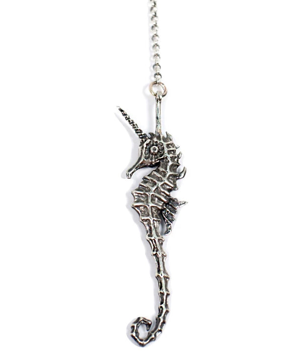 Silver seahorse pendant on a white background