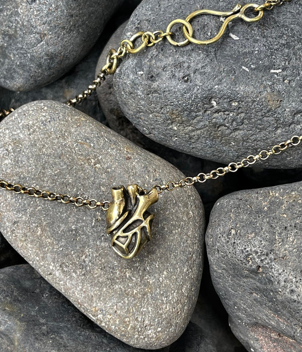 Necklace with a heart-shaped pendant on a stone background
